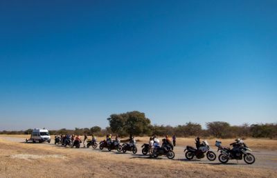 image of motorcycles parked on the side of a rode in Africa during a renedian tour. 