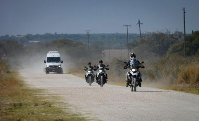 Image of three motorcycles on a gravel road in Africa followed by a chaser van while on tour with Renedian. 